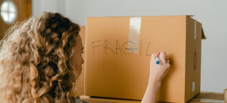 a girl packing box inside a same-day move across Los Angeles