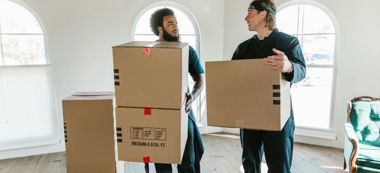 two men carrying boxes