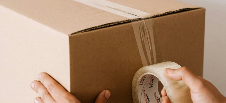 Professional mover packing boxes carefully for a move
