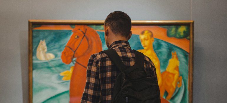 Person looking at a painting and wondering how do you move fine art in Los Angeles