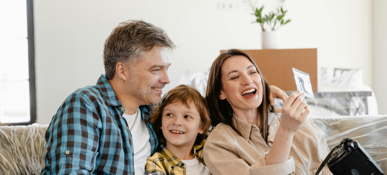 a family of three talking about what’s the best age for a child to move