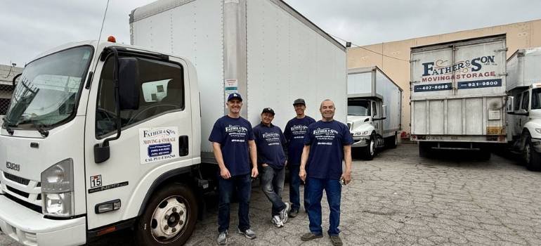 a team of local movers los angeles standing in front of a moving truck