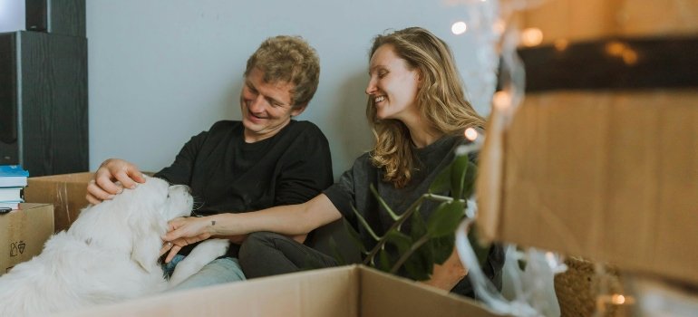 A Couple Holding their Pet Dog