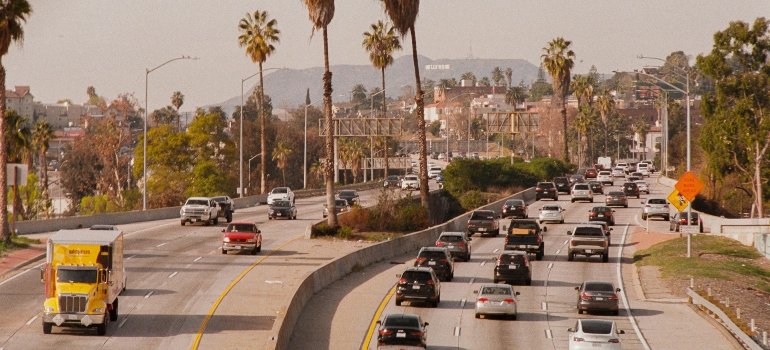 Cars driving on a busy California highway, highlighting the state’s reliance on personal vehicles over public transit.