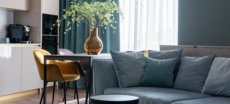 Modern studio apartment interior with sofa and kitchen zone