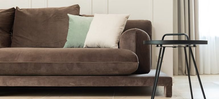 Living room with sofa near table and curtains