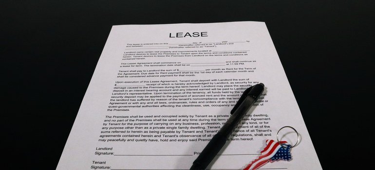 Rental lease document with pen and keys