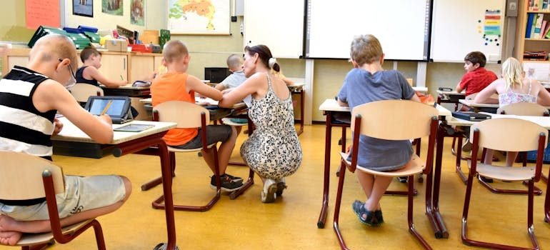 Children Sitting on Brown Chairs Inside the Classroom