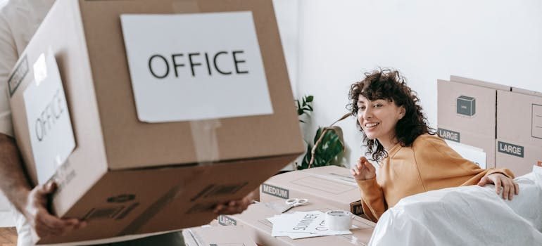Man Carrying A Box Of Office Materials
