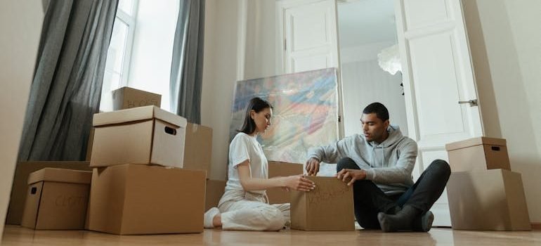 Man and Woman Sitting on Brown Sofa
