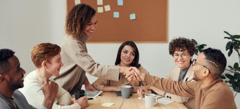 Diverse group of professionals from different ethnic backgrounds working together in a California business office.
