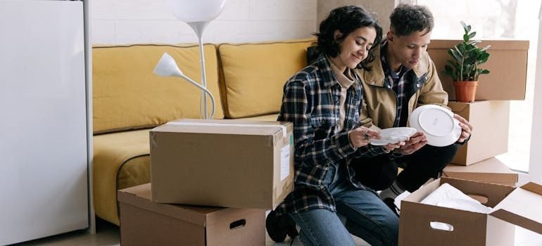 A Couple Unpacking Boxes in Their New House