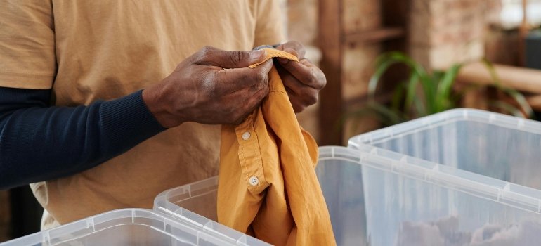 Man Holding Yellow Shirt