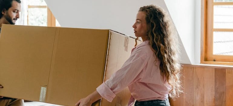Focused diverse couple relocating in new house