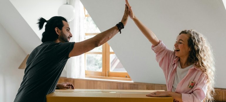 Excited couple relocating into a new apartment with help from trusted Redondo Beach movers.