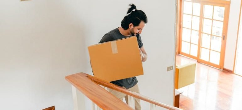 man moving carton box to new house