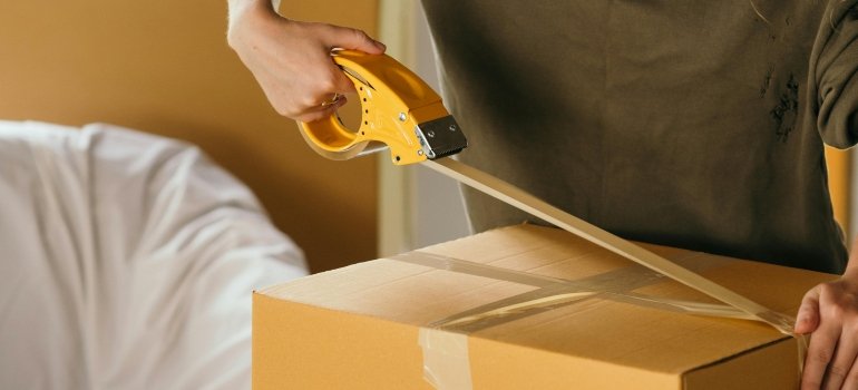 Sturdy moving boxes securely taped and stacked, ready for a work-related move to California.