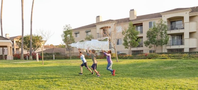 Boys Playing a Cardboard Rocket