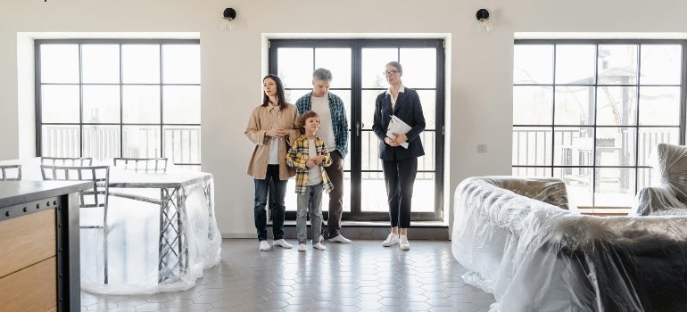 a family sitting inside their new home with freshly arranged furniture after downsizing from house to an apartment