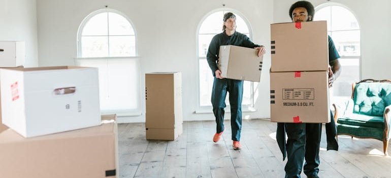 Men Carrying Boxes Inside the House