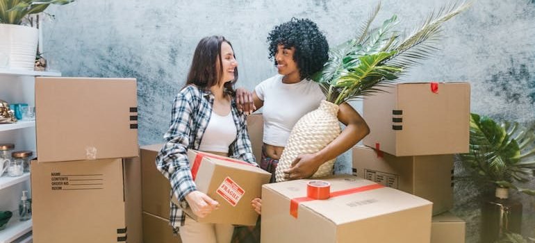 2 Women Surrounded by Boxes
