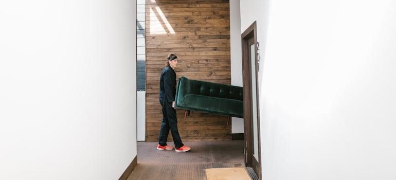 Man in Carrying a Green Sofa