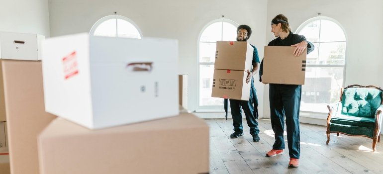 Two Men Carrying Boxes