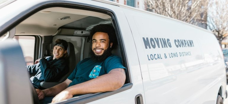 two movers van nuys are sitting in a van