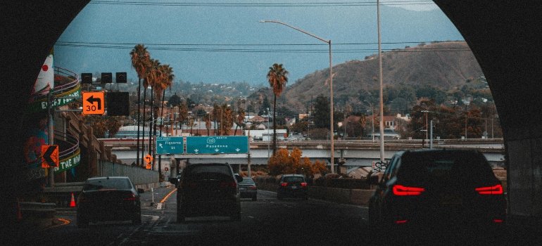 Cars in tunnel and on highway in city, showing busy traffic conditions often navigated by moving companies in South Pasadena.