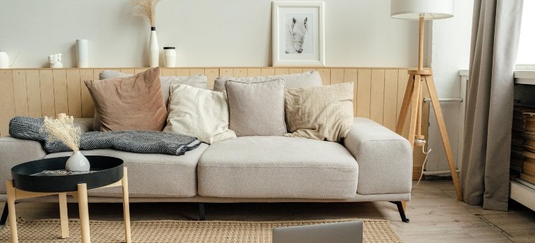 Black Laptop Computer on Brown Wooden Table and a sofa