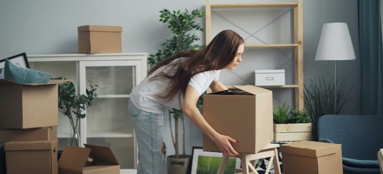 Woman with Boxes in House