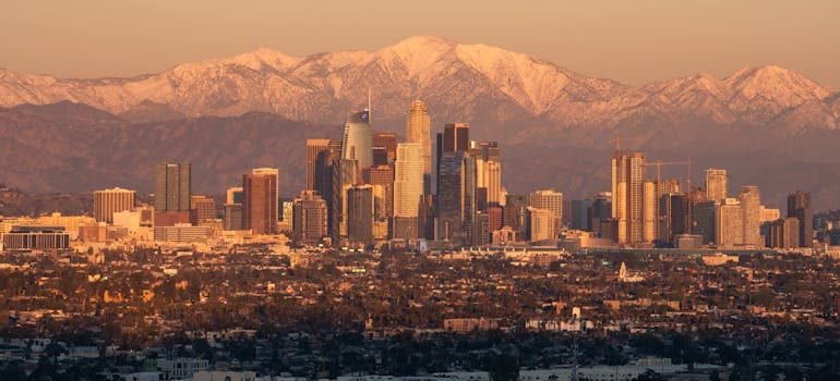 Golden Hour Los Angeles Skyline with Snowy Mountains
