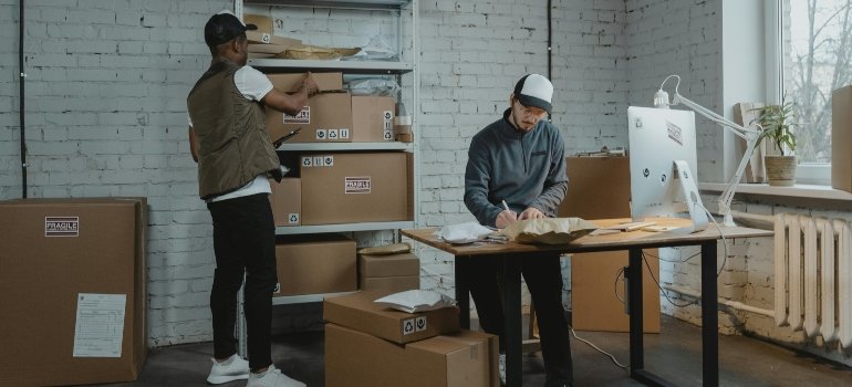 Professional movers sorting packages