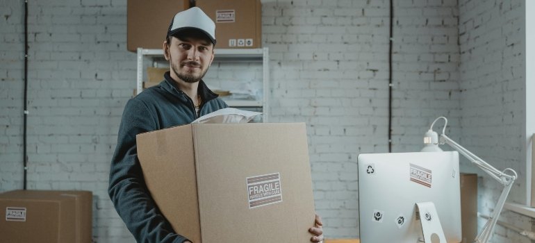 Professional mover packing fragile items with protective materials to prevent damage during a move