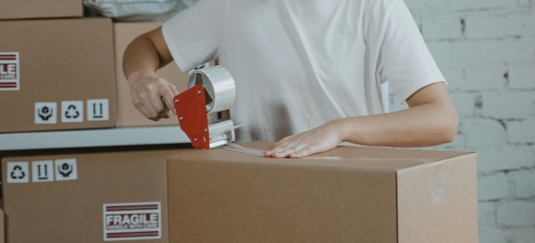 Professional mover carefully packing items.